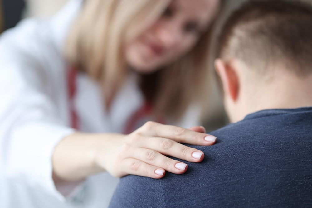 Female,Doctor,Holding,Shoulder,Of,Male,Patient,Closeup.,Psychological,Support